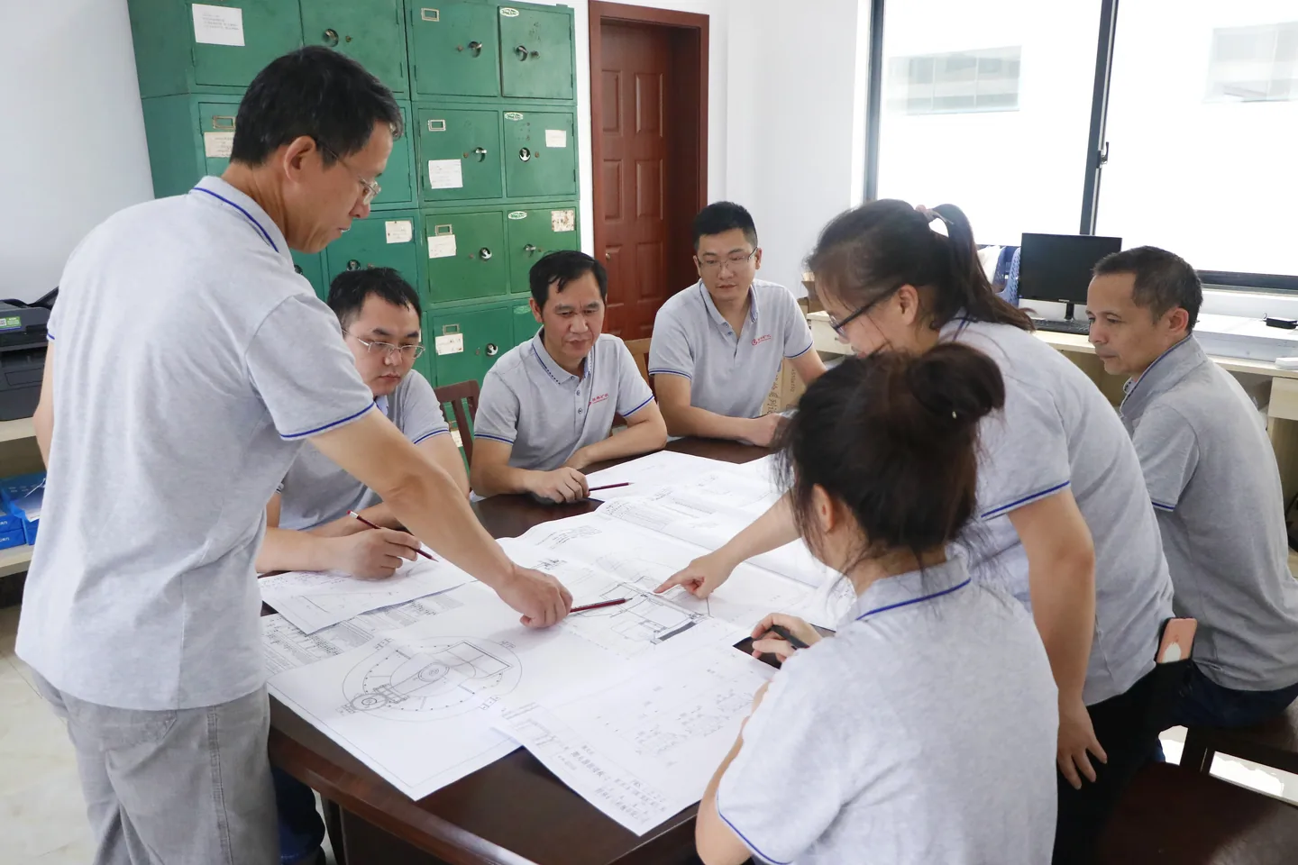 Cronus technical team discussing powder grinding engineering